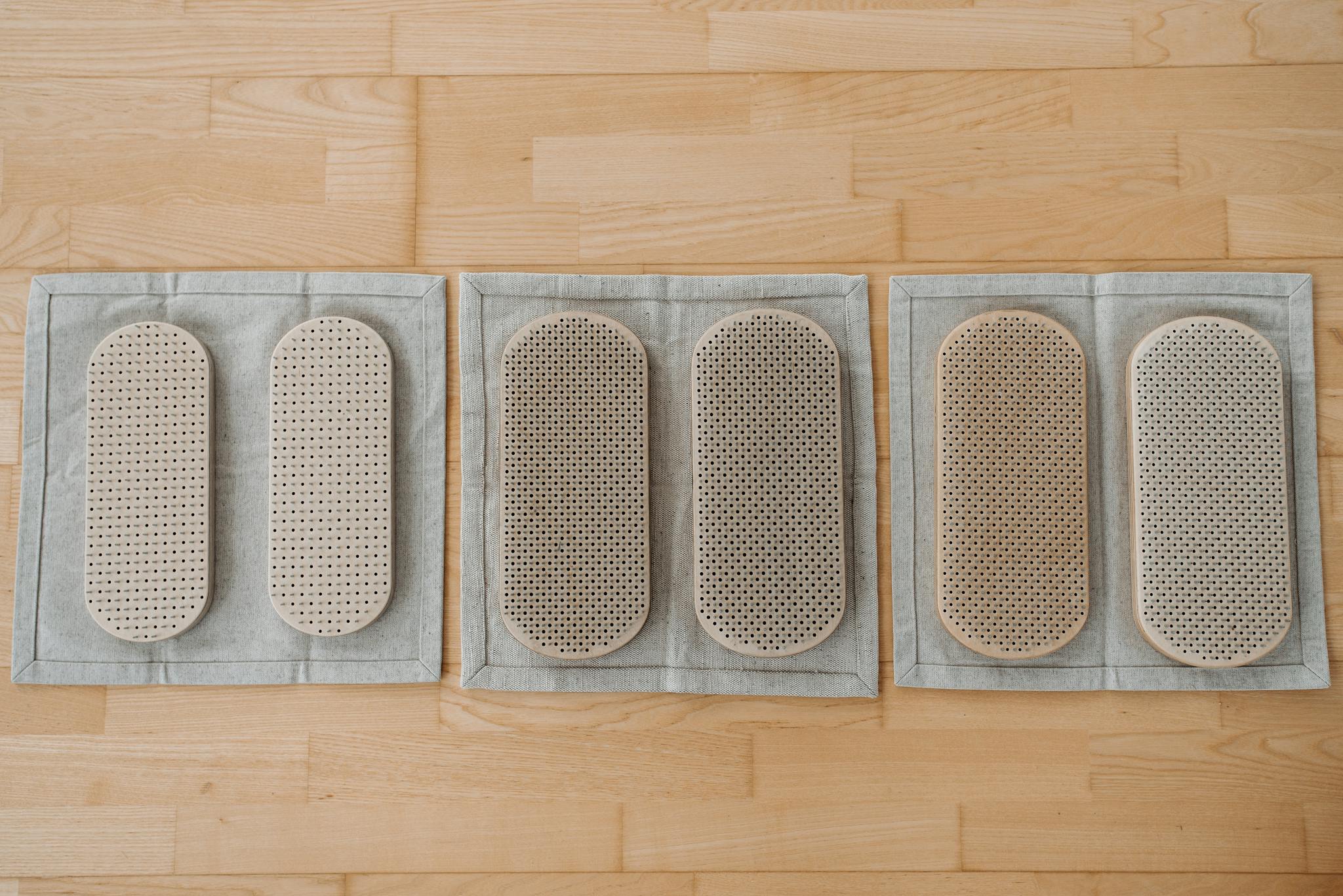 Top view of three meditation boards on a wooden floor for relaxation therapy.